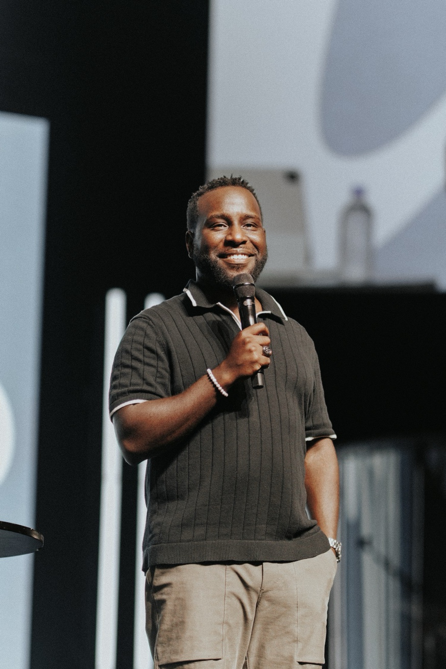 Peter Reeves speaking on stage with a microphone